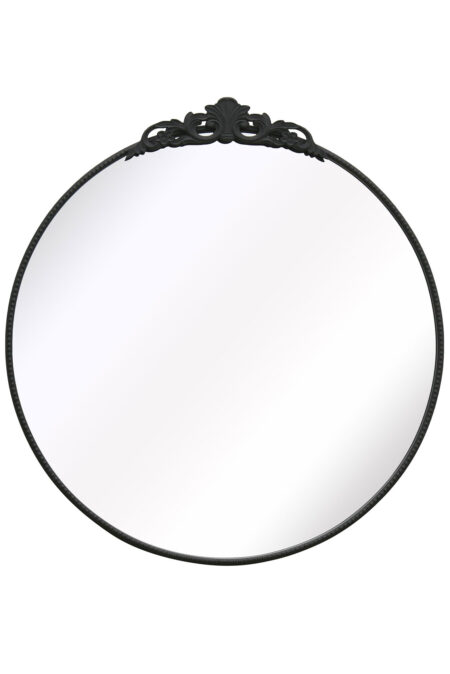 Front view of a round black mirror with ornate scrollwork crest on a white background
