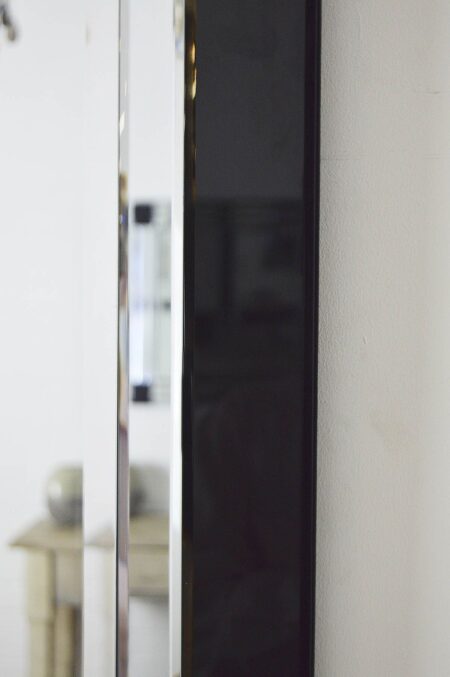 This black all glass wall mirror is available to purchase here at The Mirror Man